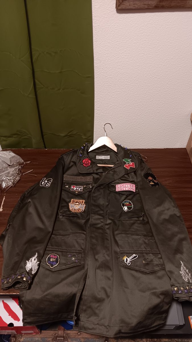 Spine Collector jacket — front with rose patch and assorted patches