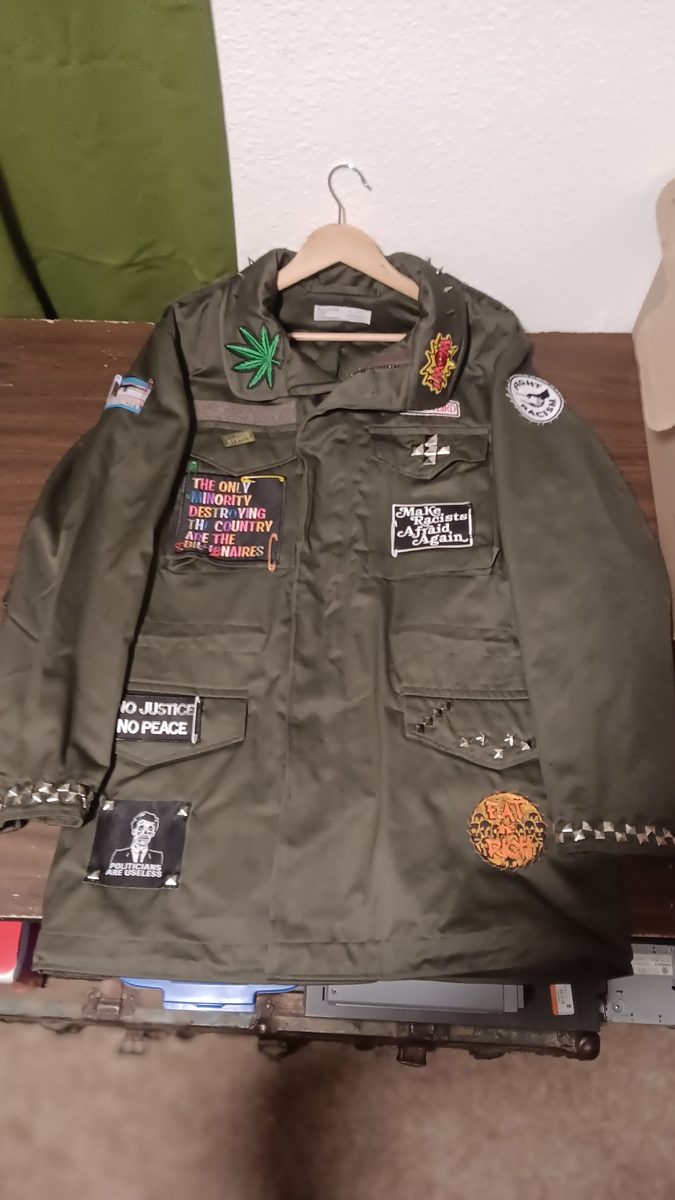 Activist Army jacket — front with political patches and studded collar