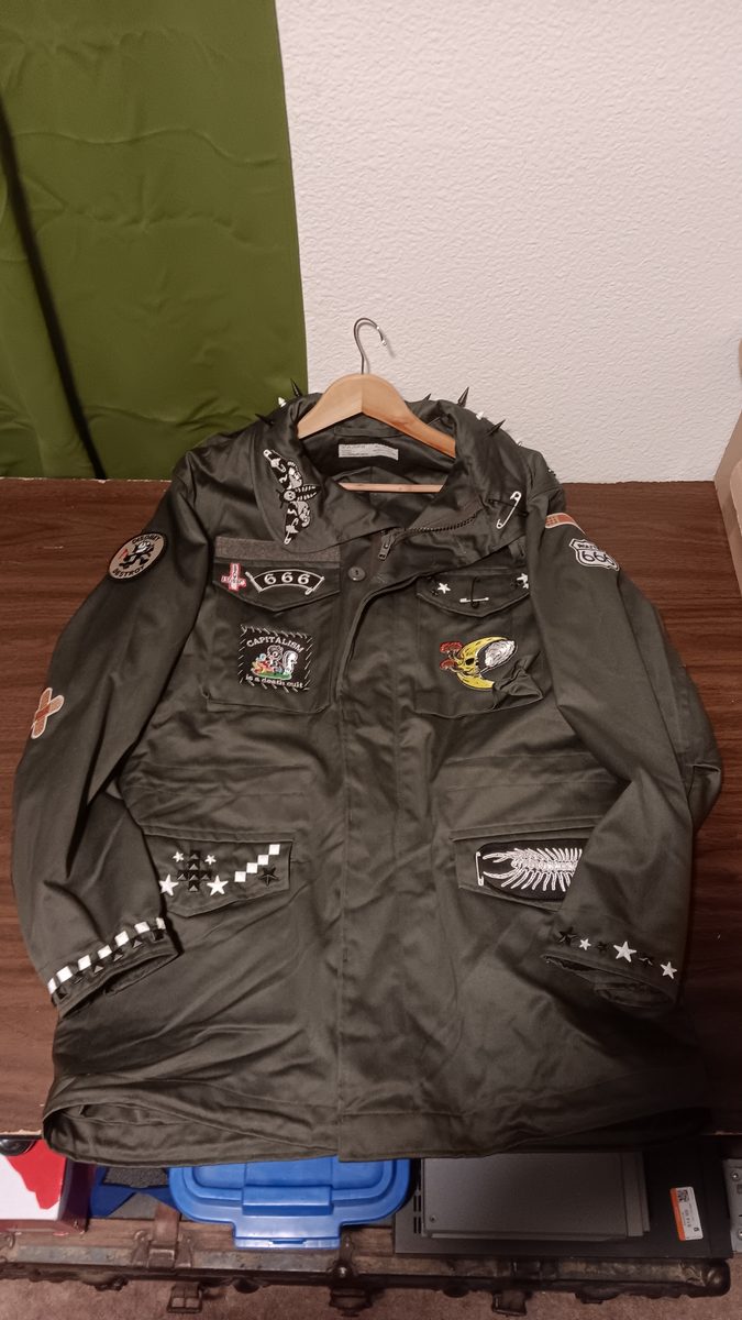See You In Hell jacket — front with skull patches, spikes, and checkered trim