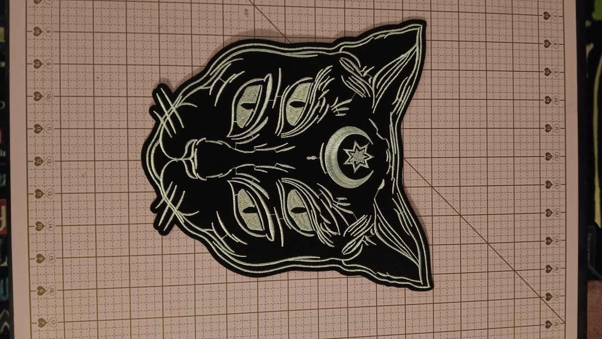 Four-eyed black cat with moon and star